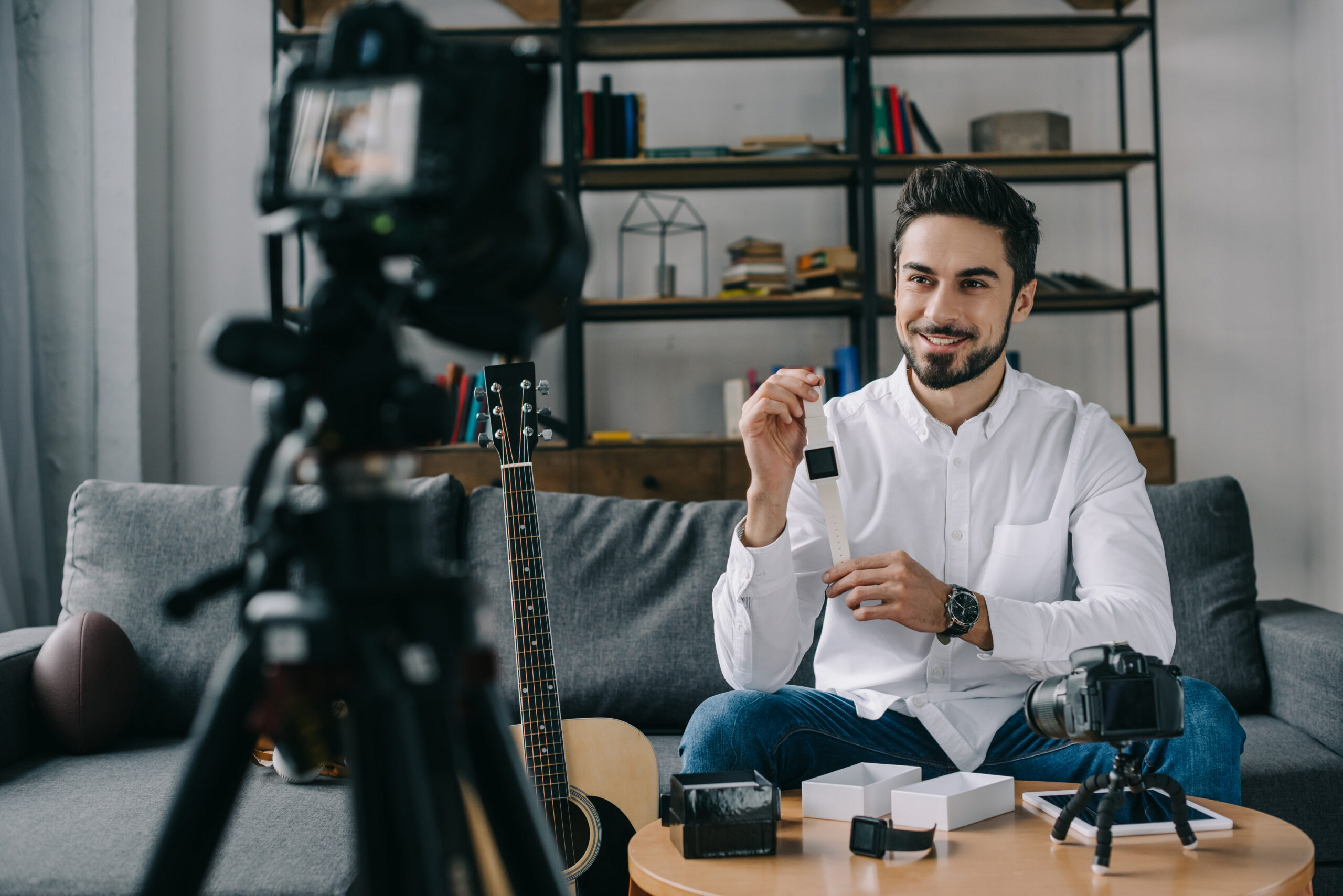 smiling technology blogger recording new vlog about smart watch